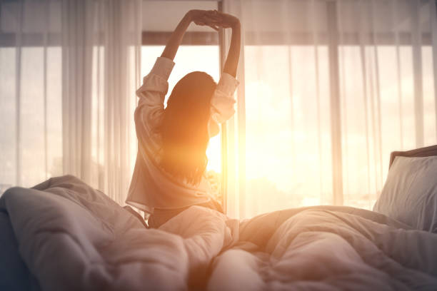 Woman waking up from a restful nights sleep