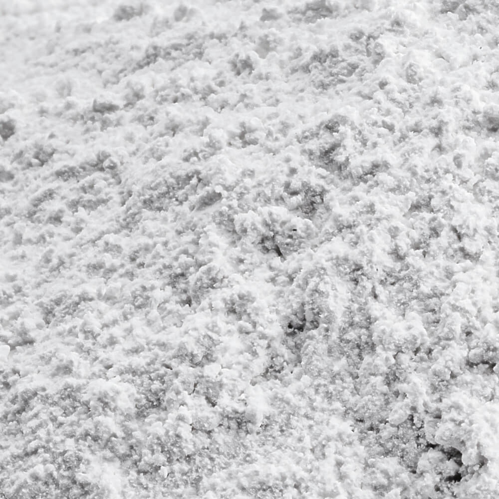 A close-up texture shot of a white, granular, crystalline powder filling the entire frame.